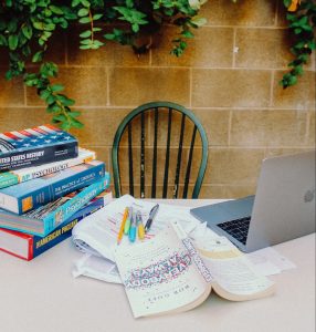 textbooks with pens and pencils for annotating