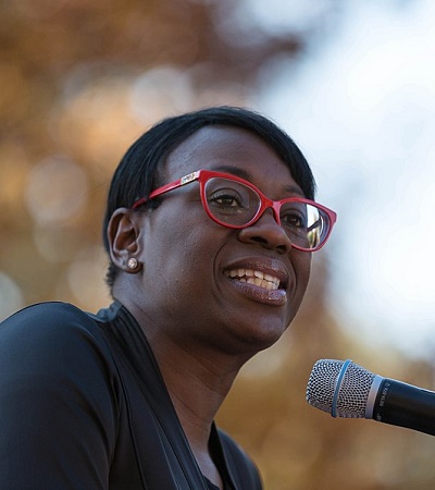 Decorative: A woman speaking into a microphone.