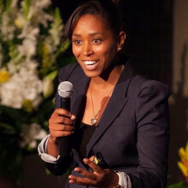 Decorative: A woman speaking using a microphone.