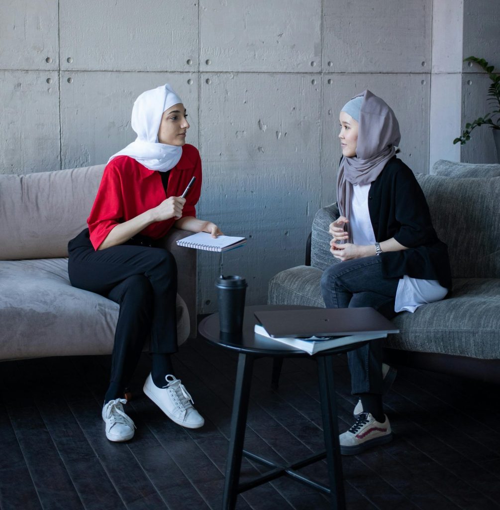 Figure 6.2 Photo of two women facing each other with good eye contact, talking and listening.