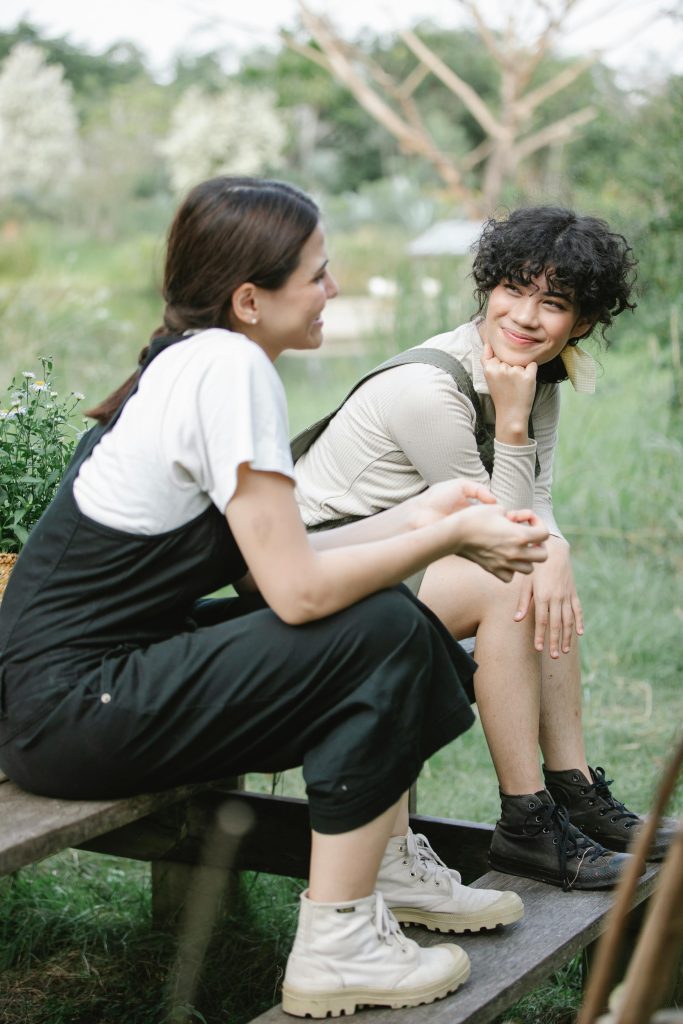 Cheerful gardeners on wooden bench in garden