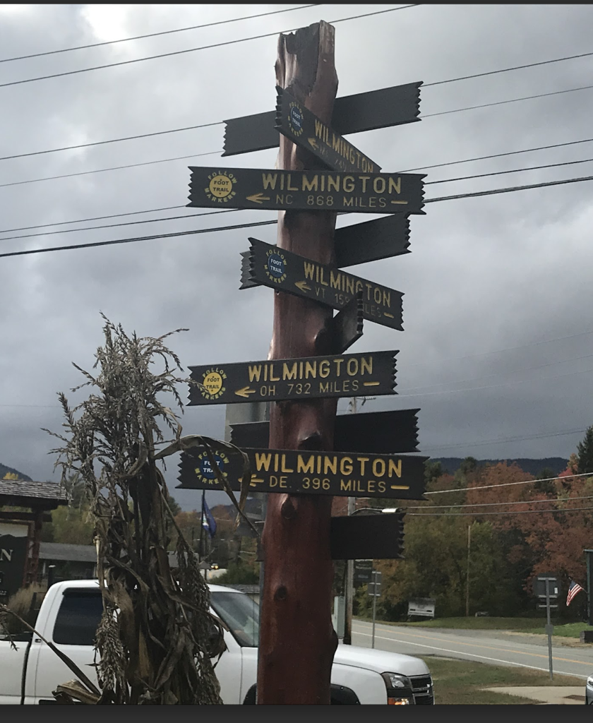 Relative location: sign in Wilmington, NY pointing to other Wilmington locations in the US