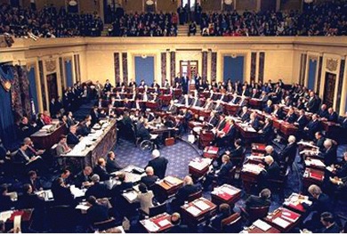 Wide view of the United States Senate chamber during the impeachment trial of Bill Clinton, showing many senators seated at their desks.